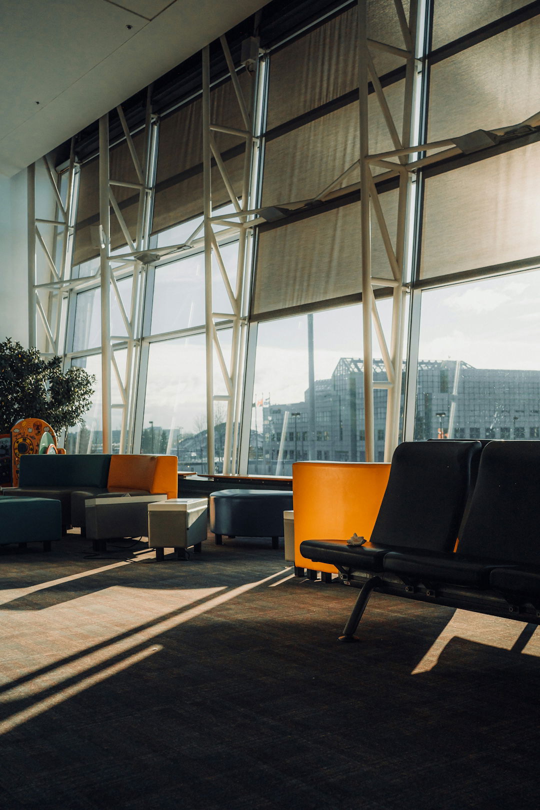 Modern waiting area with large windows and seating.